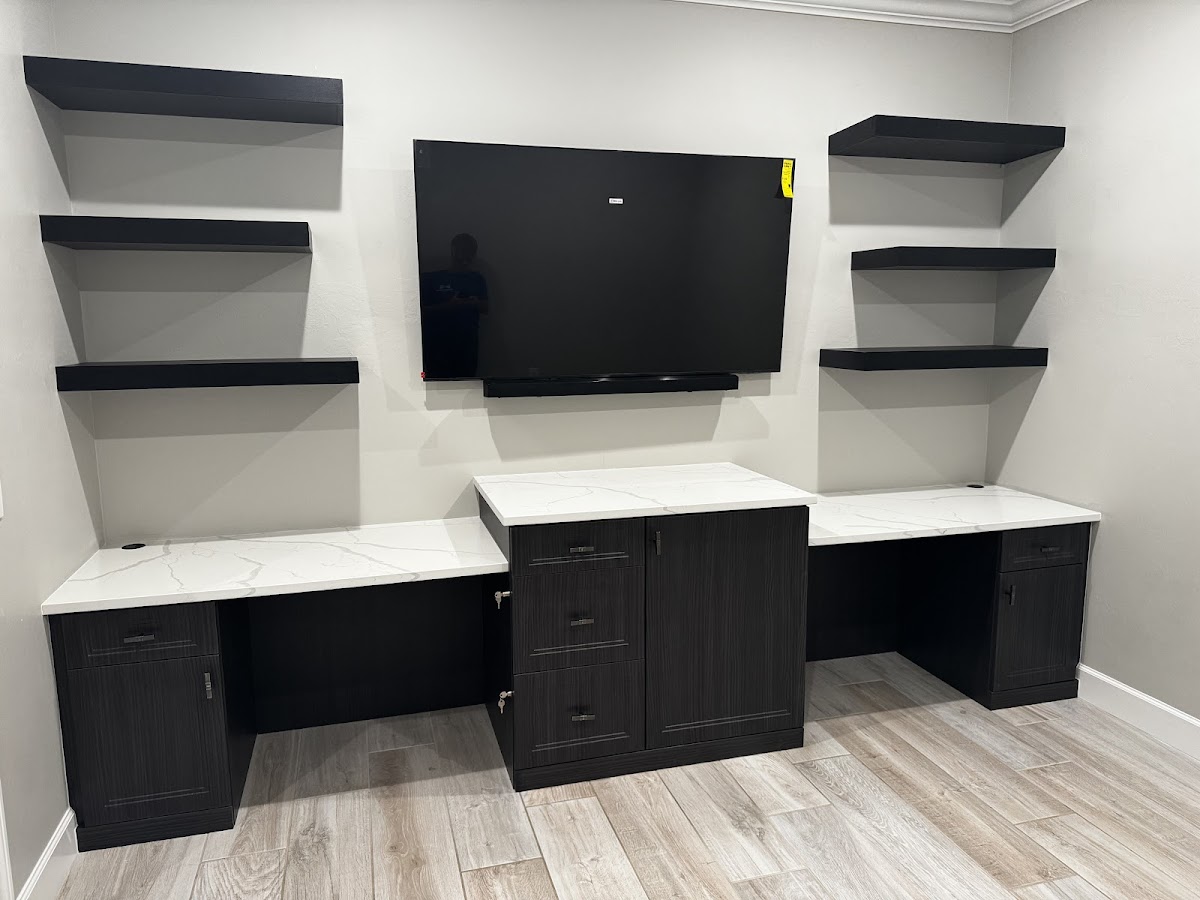 Dark wood dual desk setup with floating shelves and wall-mounted TV in Bradenton FL