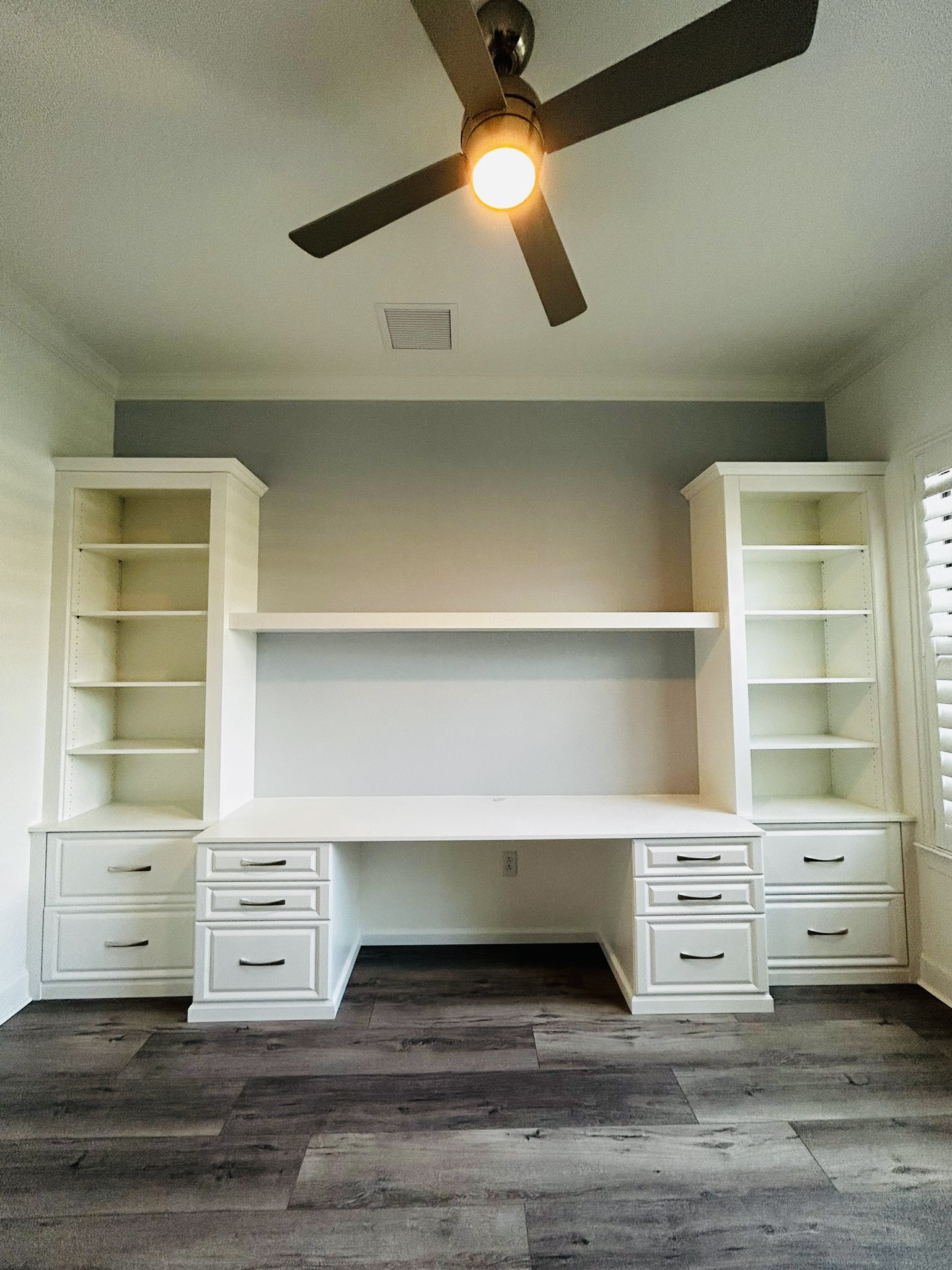 Bright white walk-in closet with custom shelving, drawers, and hanging zones in Bradenton FL